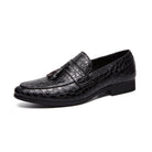 Black leather loafer with tassel on a white background