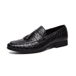 Black leather loafer with tassel on a white background