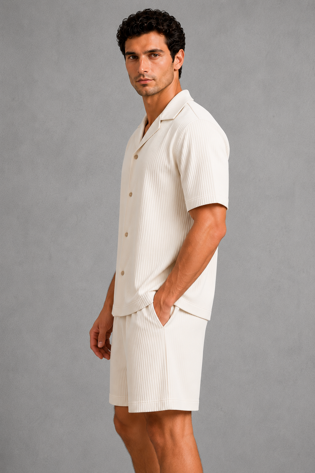 Man wearing a white outfit against a gray background