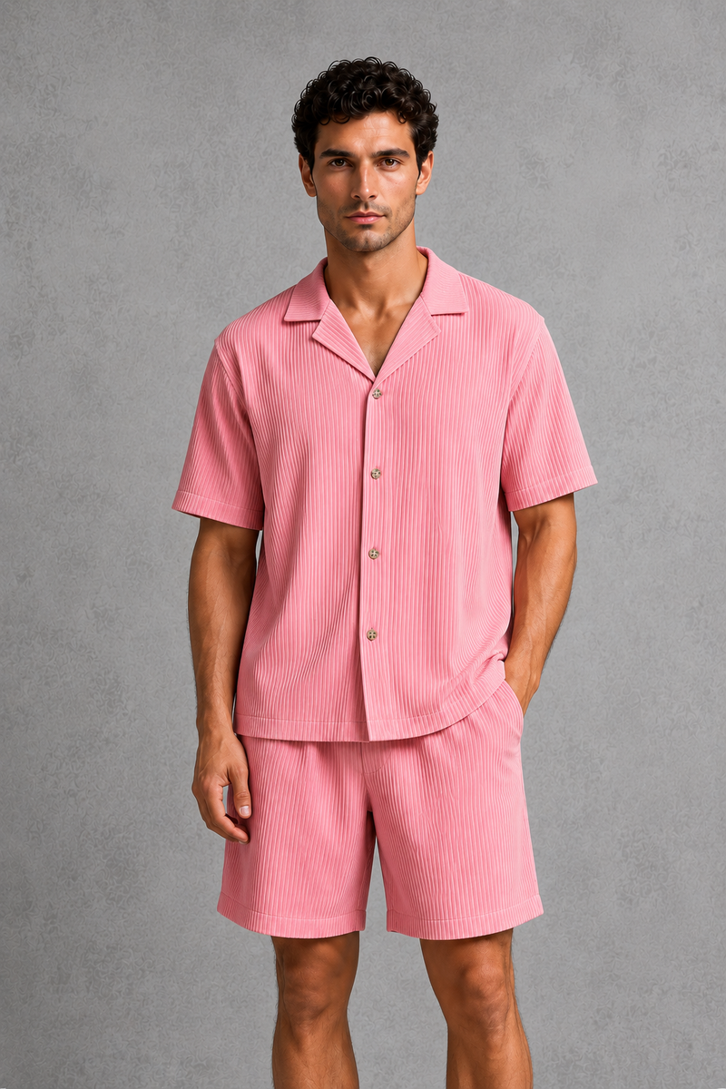 Man wearing a pink pajama set against a gray background