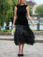 Raffia knit midi dress with tassel detailing and stretch fit silhouette