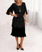 Woman wearing a black dress with a white background
