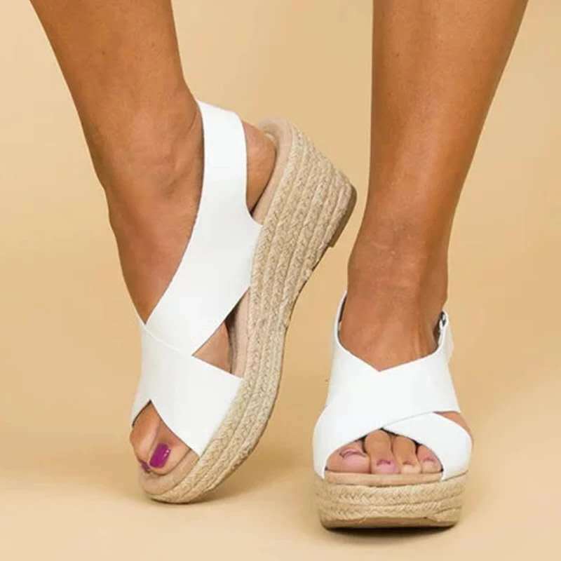 White sandals with jute wedge sole on a beige background