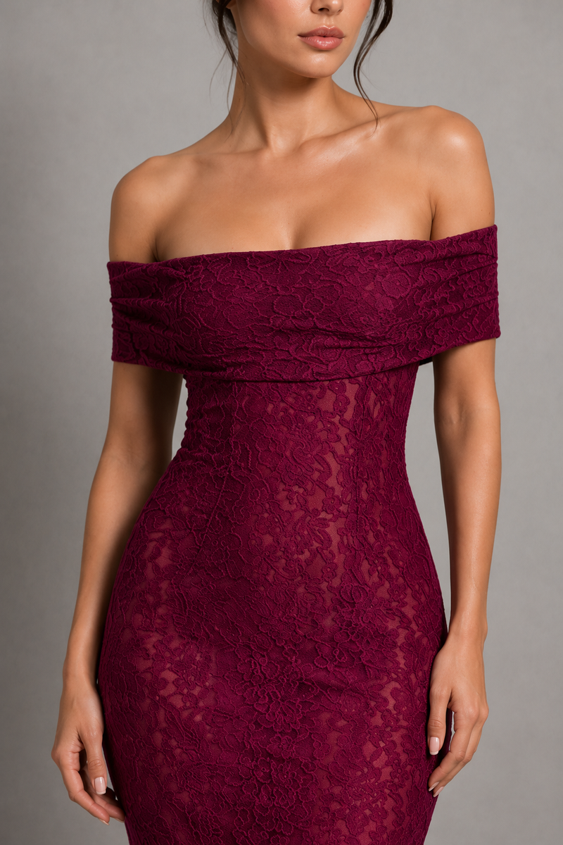 Woman wearing a burgundy off-shoulder lace dress against a gray background