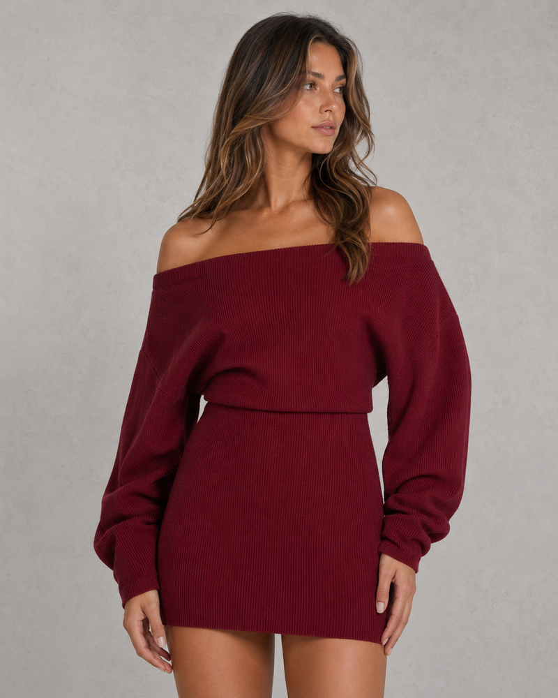 Woman wearing a burgundy off-shoulder sweater dress against a gray background
