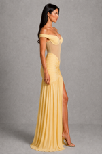 Woman wearing a yellow evening gown with a gray background