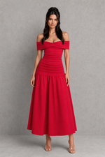 Woman wearing a red off-shoulder dress against a gray background
