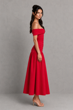 Woman wearing a red off-shoulder dress against a gray background