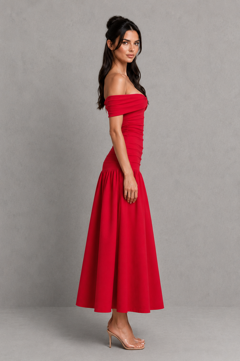 Woman wearing a red off-shoulder dress against a gray background