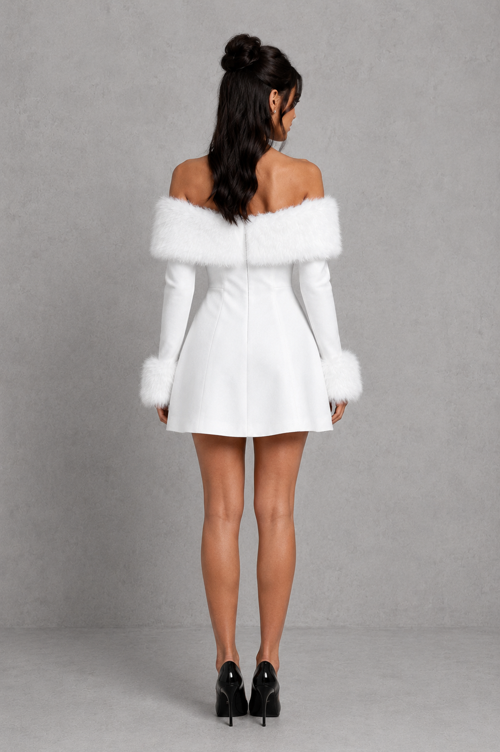 Woman wearing a white off-shoulder dress with fur trim against a gray background