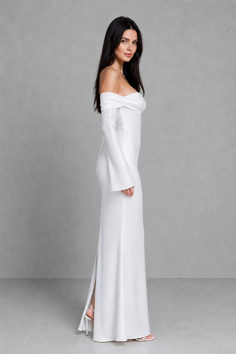 Woman wearing a white off-shoulder dress against a gray background