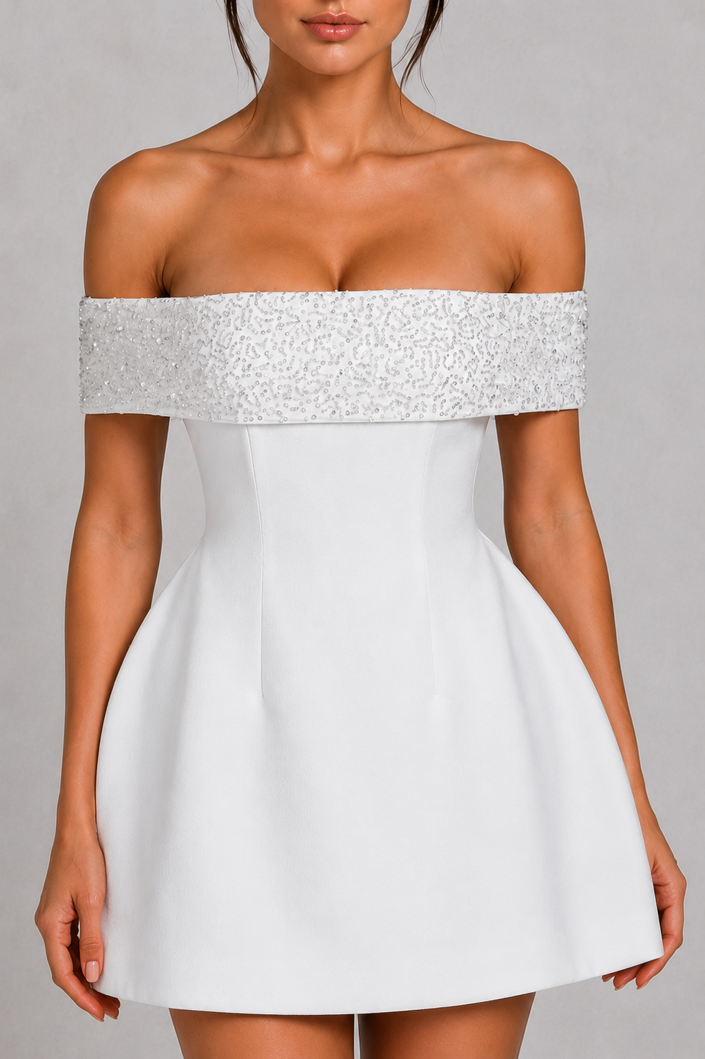White off-shoulder dress with silver embellishments on a gray background