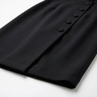 Black skirt with button details on a white background