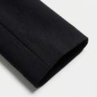 Close-up of a black fabric roll on a white background