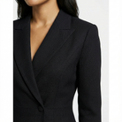 Black blazer worn by a person on a white background