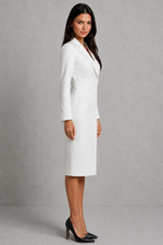Woman wearing a white suit against a gray background