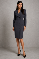 Woman wearing a gray suit against a plain background