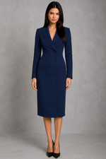 Woman wearing a navy blue suit dress against a gray background