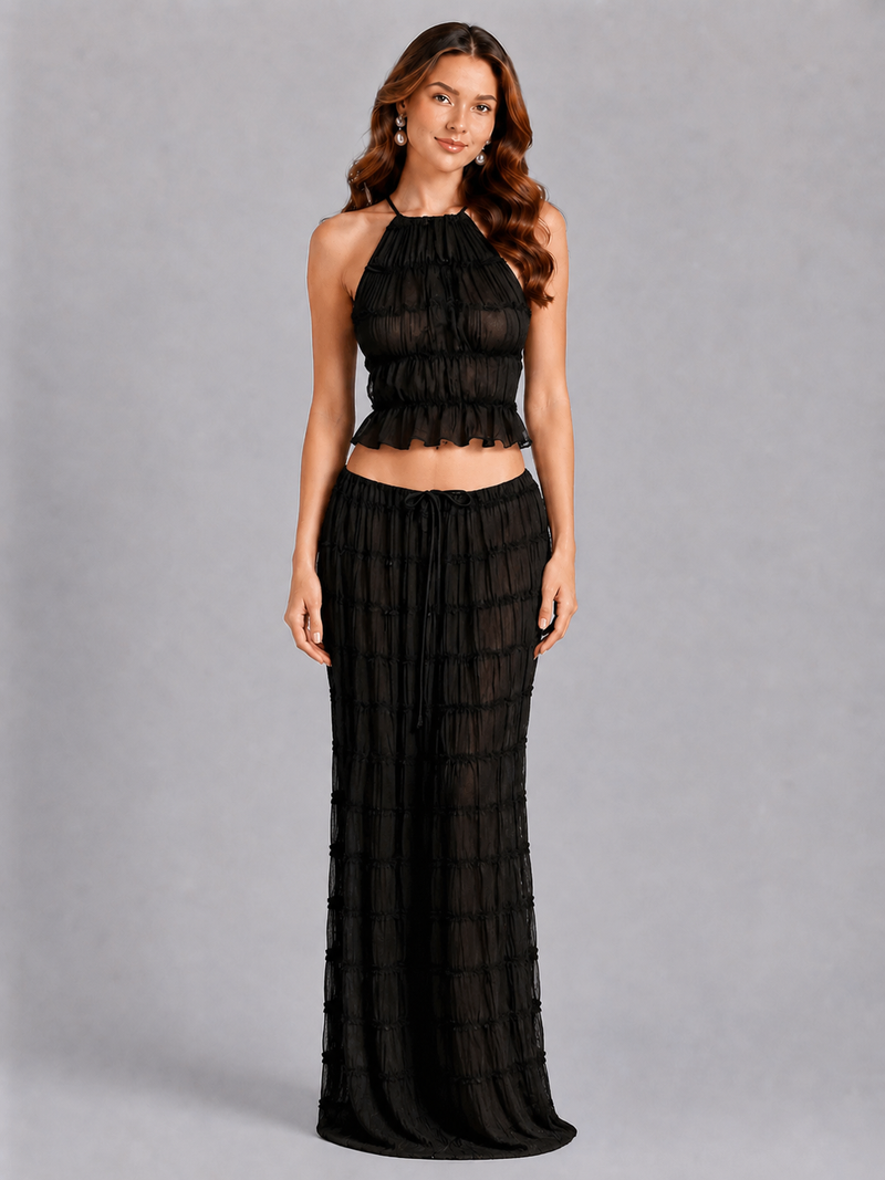 Woman wearing a black dress against a gray background