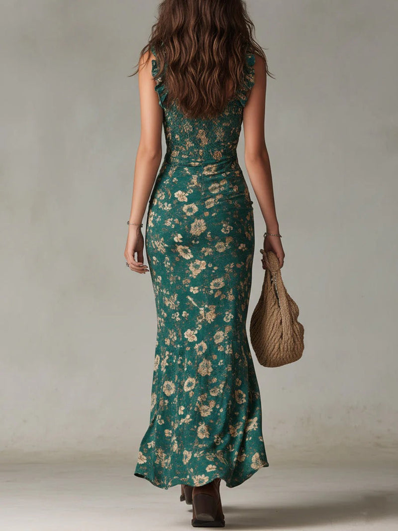 Woman wearing a green floral dress holding a woven bag against a neutral background