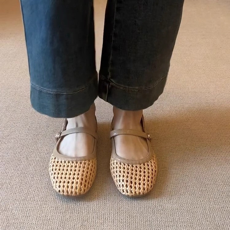 Person wearing beige mesh shoes with dark jeans on a neutral carpeted floor