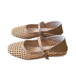 Pair of beige woven shoes with a strap on a white background