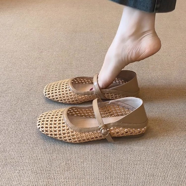Beige woven shoes worn by a person on a beige carpet