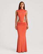 Woman wearing a coral dress with cut-out design on a white background
