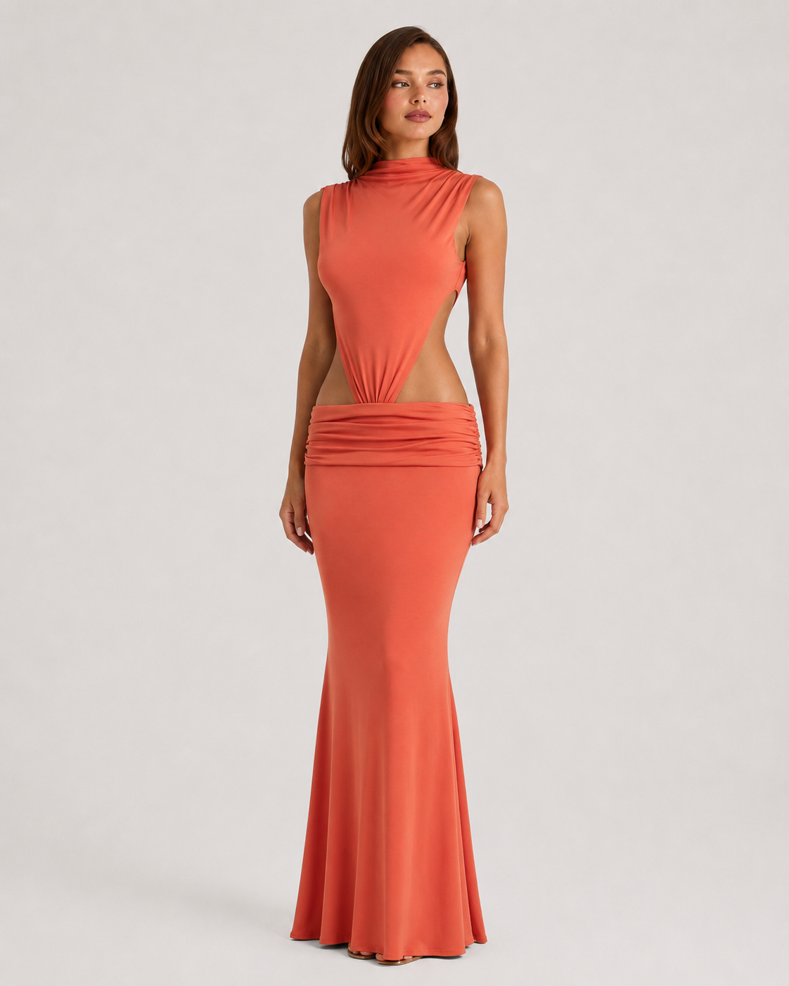 Coral evening gown with sheer details on a white background
