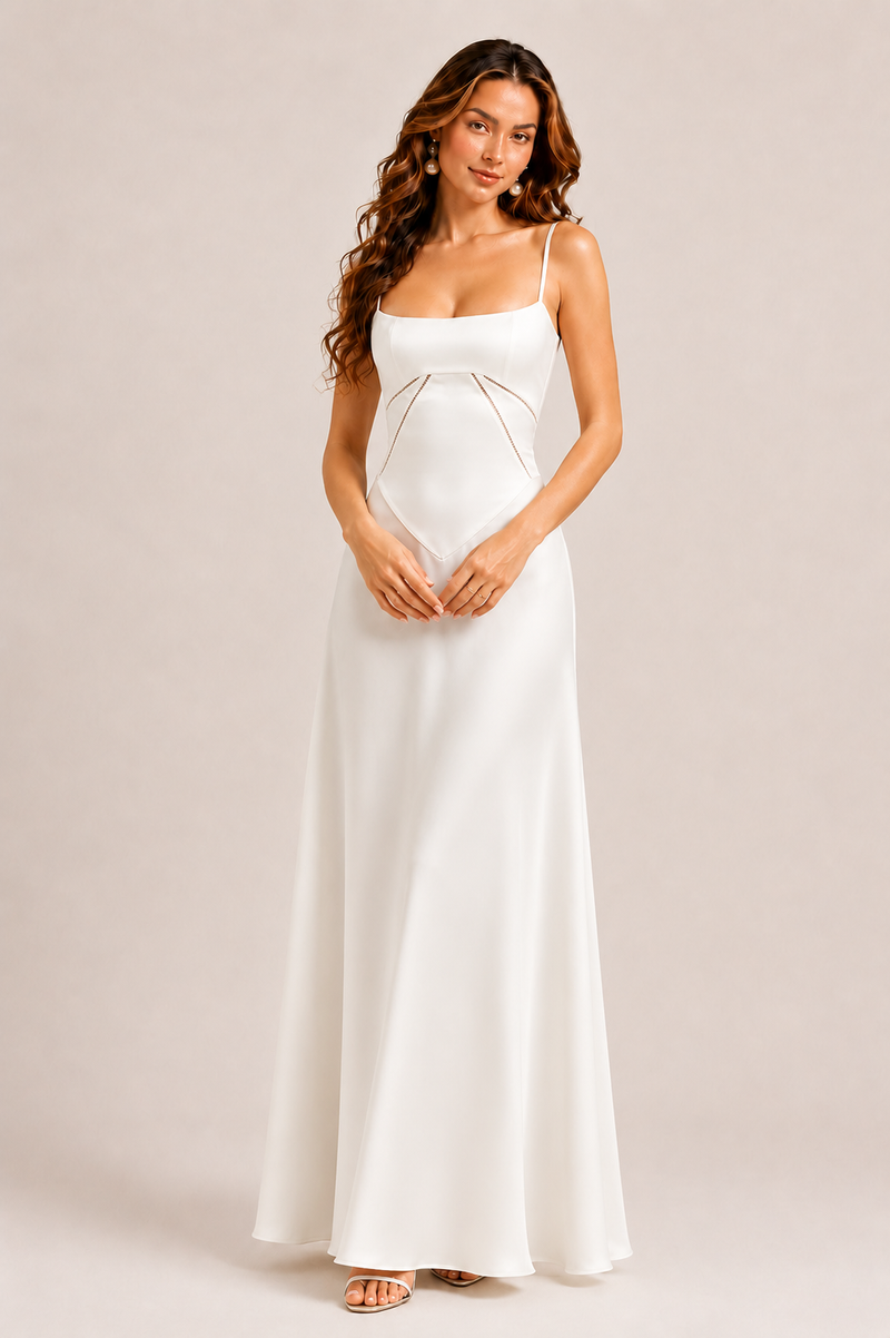 Woman wearing a white dress against a plain background
