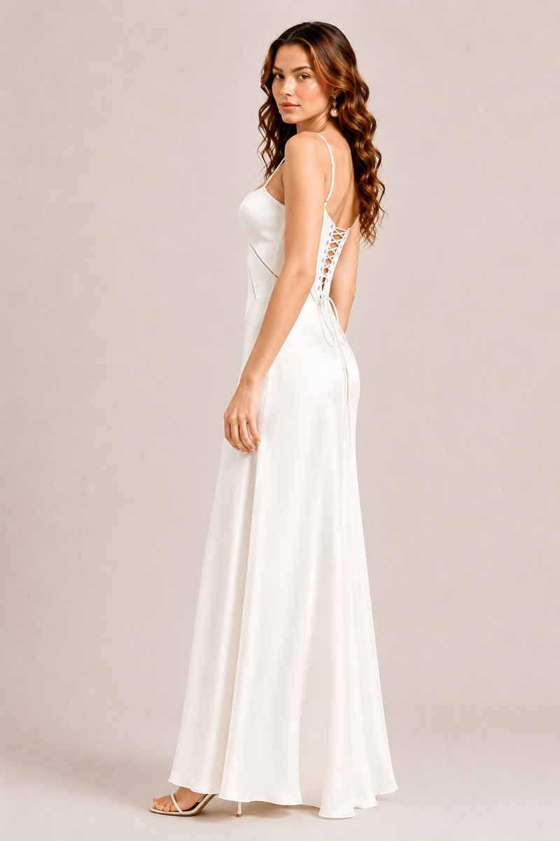 Woman wearing a white dress with lace details on a beige background