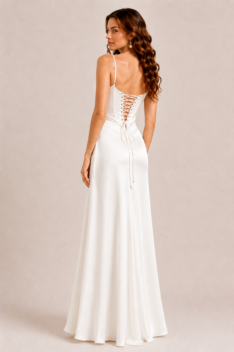Woman wearing a white dress with lace-up back on a beige background
