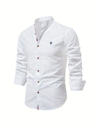 White button-up shirt with a small logo on a white background