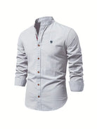 Light blue button-up shirt with a small logo on a white background
