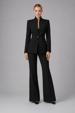 Woman wearing a black suit on a gray background