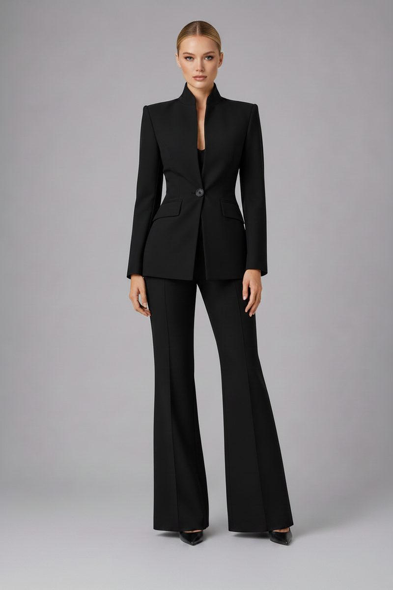 Woman wearing a black suit on a gray background