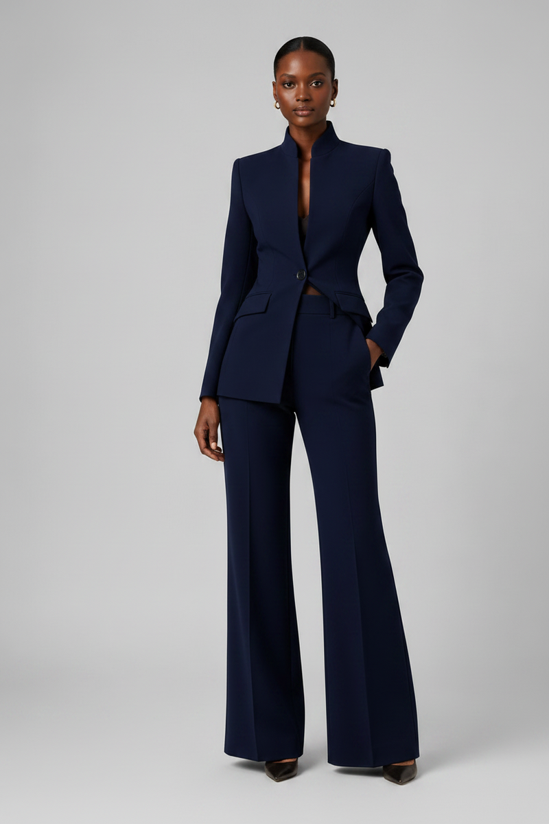 Woman wearing a navy blue suit on a gray background