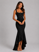 Woman wearing a black evening gown on a gray background