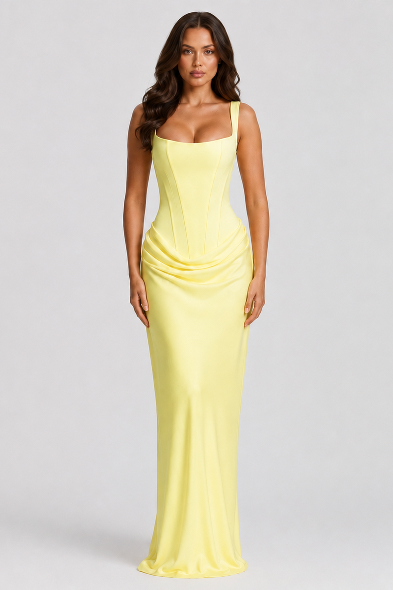 Woman wearing a yellow evening gown on a gray background