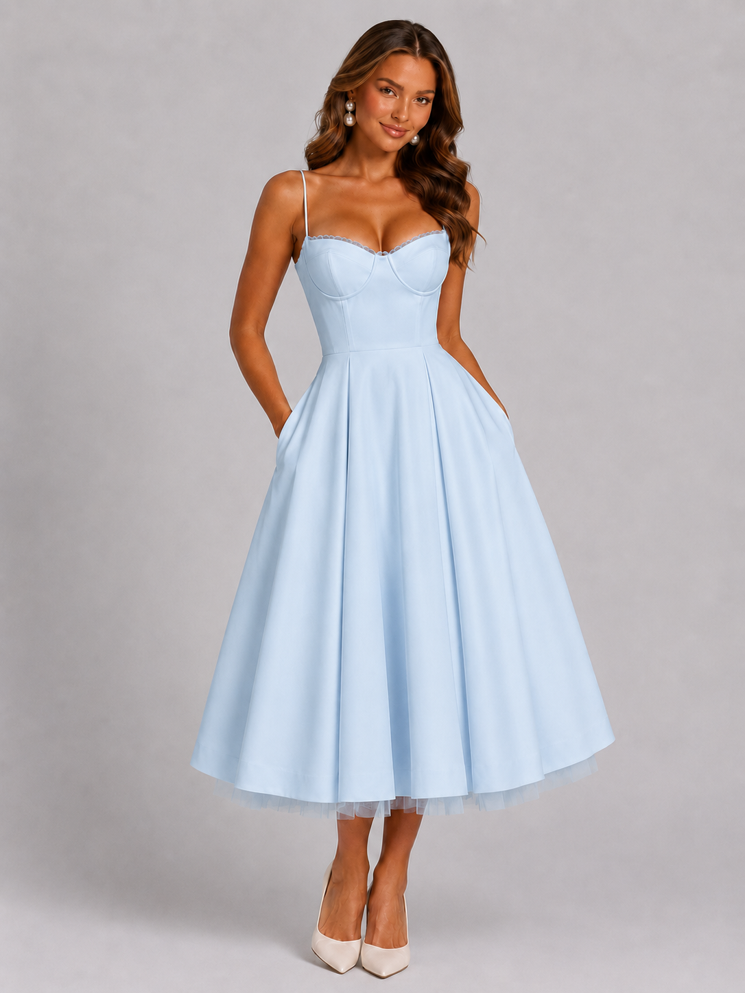 Woman wearing a light blue dress on a gray background