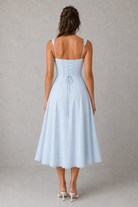 Light blue dress with thin straps on a gray background