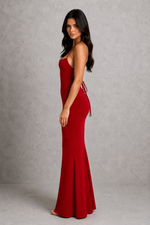 Woman wearing a red evening gown against a gray background