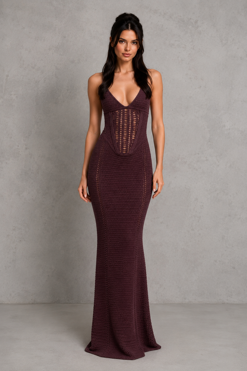 Woman wearing a burgundy evening gown against a gray background