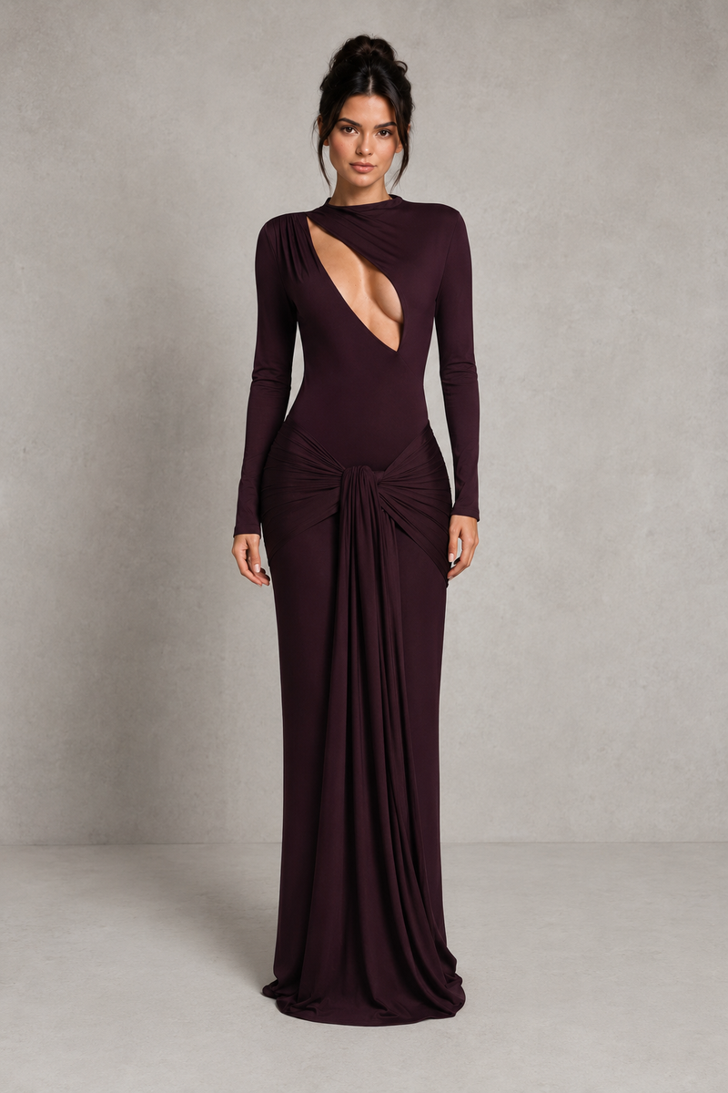 Woman wearing a long burgundy evening gown with a deep neckline against a neutral background