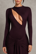 Dark purple dress with long sleeves and a deep neckline on a neutral background