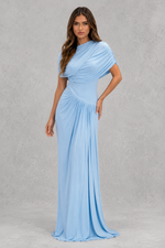 Woman wearing a light blue gown against a gray background