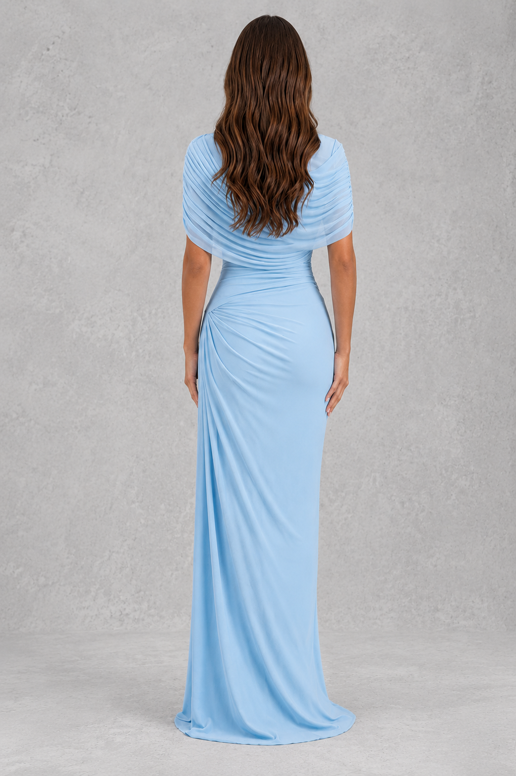 Woman wearing a light blue evening gown against a gray background