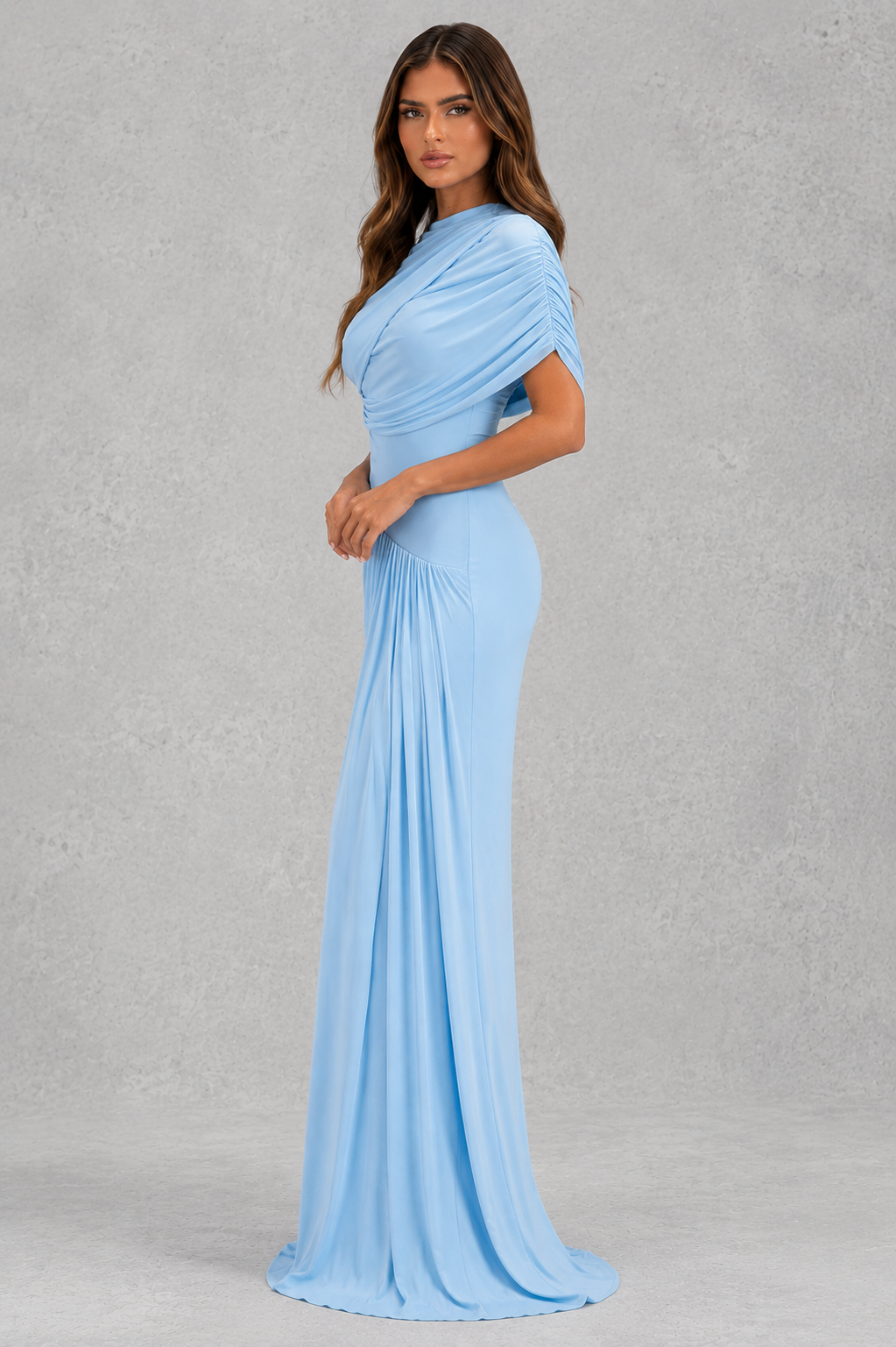 Woman wearing a light blue evening gown against a gray background