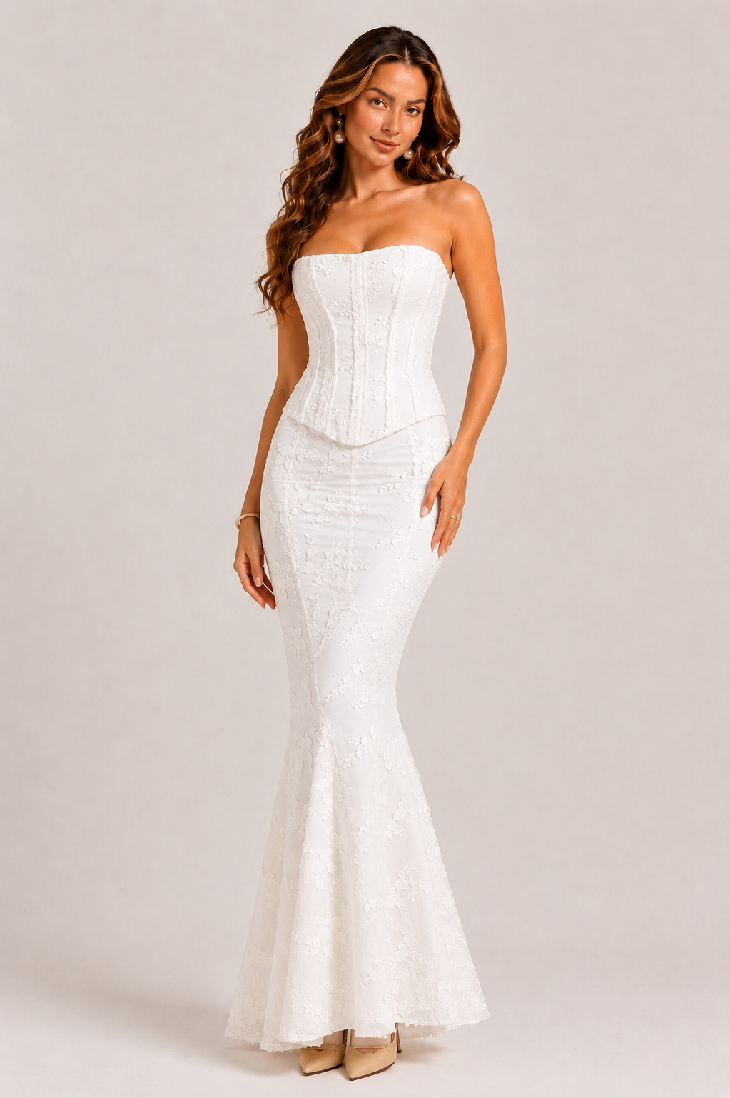 Woman wearing a white strapless gown on a plain background