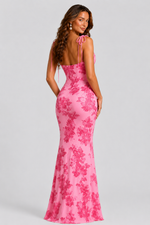 Pink floral dress worn by a model on a gray background